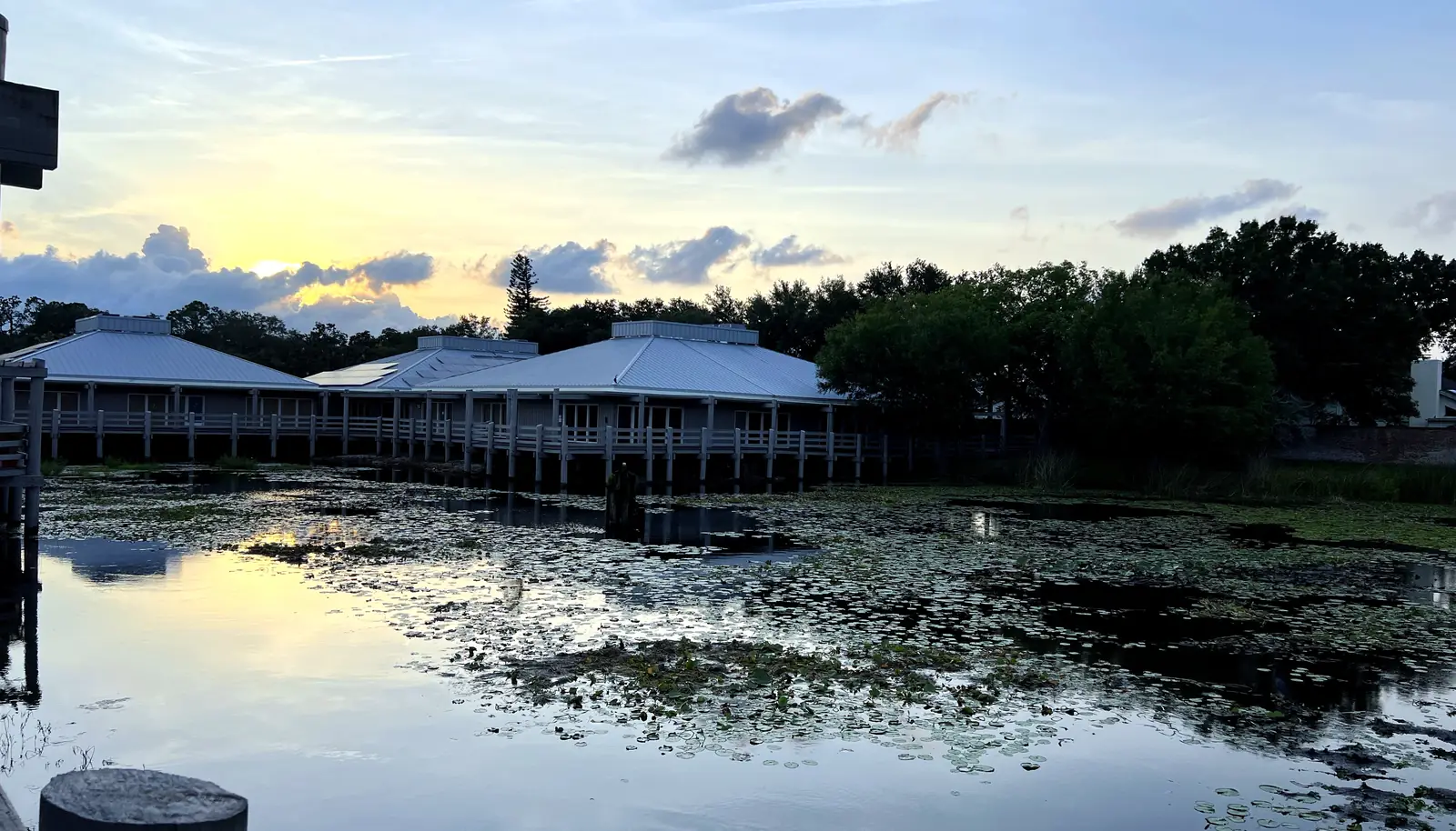 The firm's office at golden hour, mirrored in its office-park pond